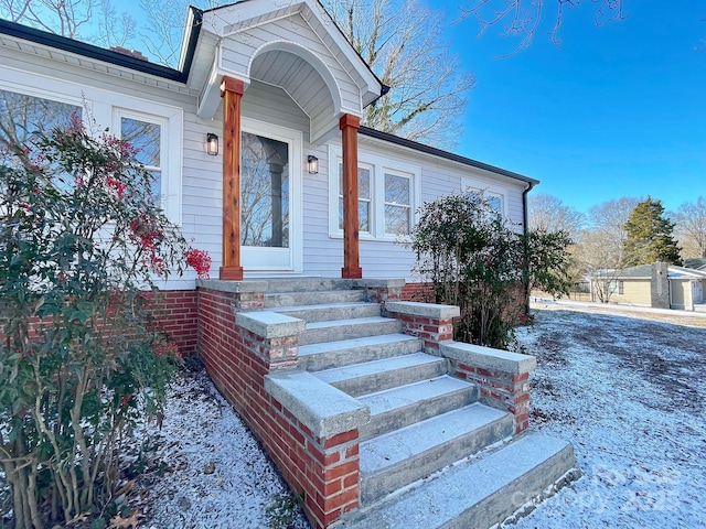 view of snow covered property entrance