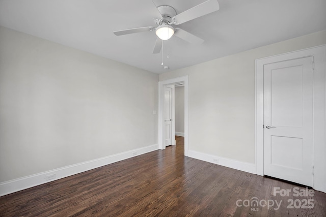 empty room featuring ceiling fan and dark wood-type flooring