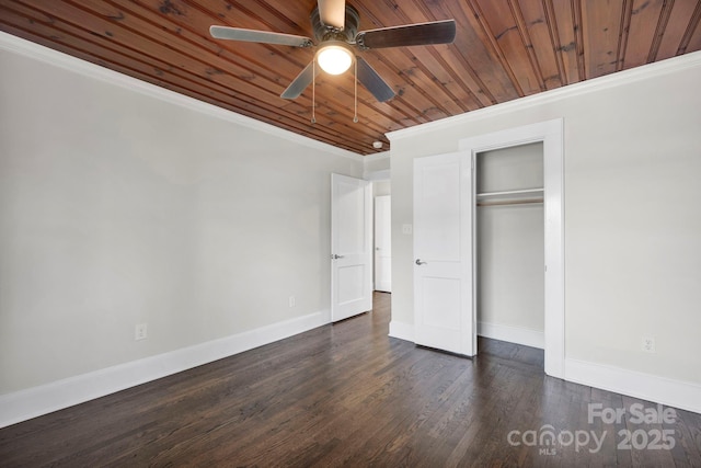 unfurnished bedroom featuring dark hardwood / wood-style flooring, a closet, ornamental molding, ceiling fan, and wooden ceiling