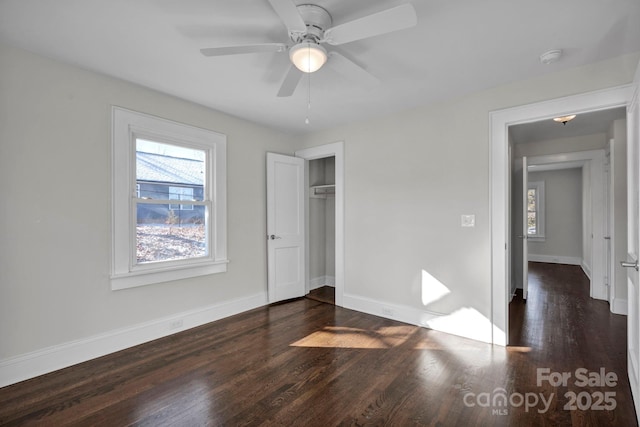 unfurnished bedroom with a closet, ceiling fan, and dark wood-type flooring