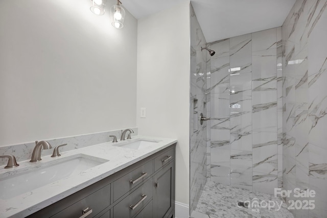 bathroom with tiled shower and vanity