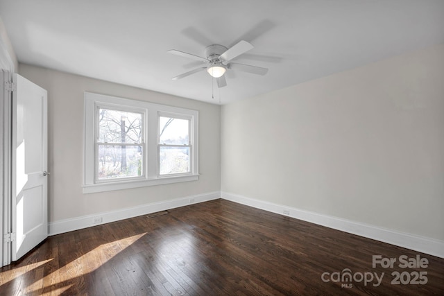 unfurnished room featuring ceiling fan and dark hardwood / wood-style flooring