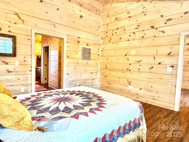 bedroom with dark hardwood / wood-style floors and wooden walls