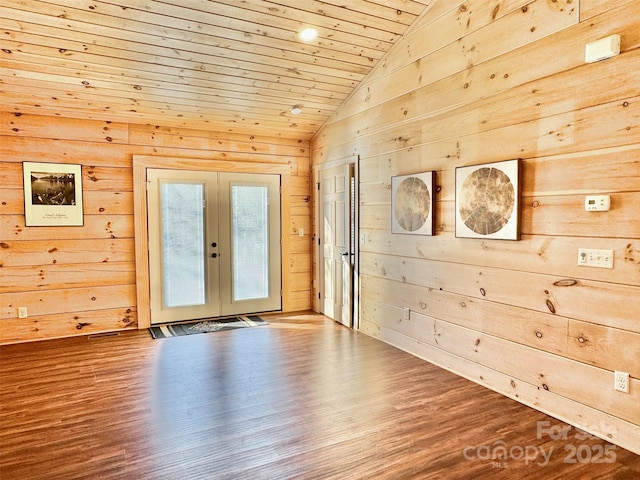 doorway to outside featuring hardwood / wood-style floors, wooden walls, lofted ceiling, wood ceiling, and french doors