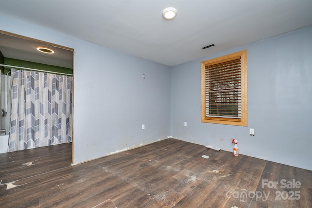 spare room featuring dark hardwood / wood-style floors