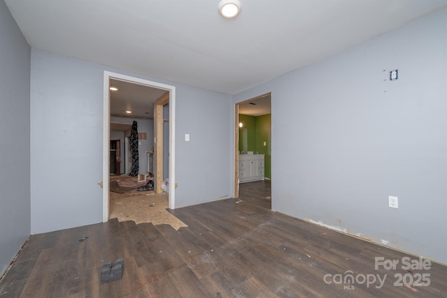 spare room featuring dark wood-type flooring