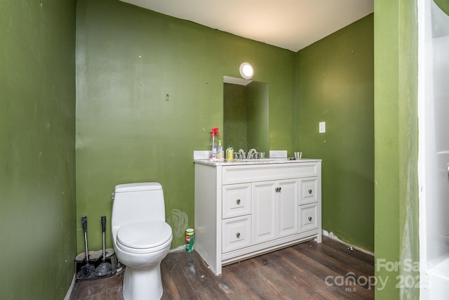 bathroom featuring hardwood / wood-style floors, toilet, and vanity