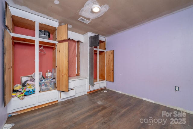 unfurnished bedroom with dark hardwood / wood-style flooring