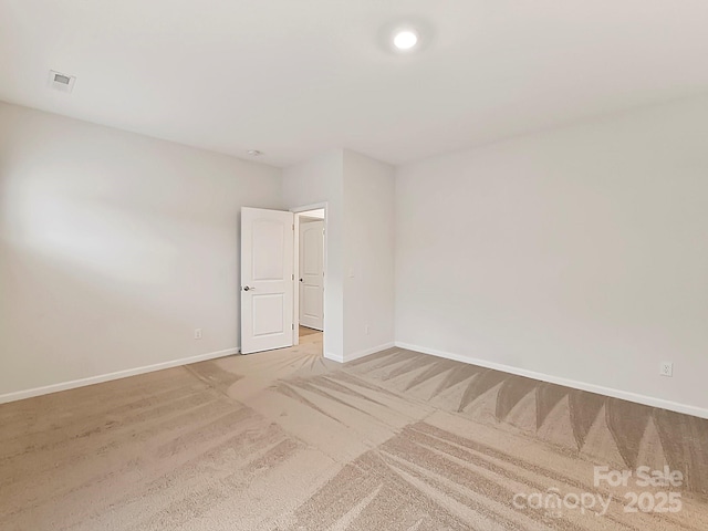 unfurnished room with light carpet