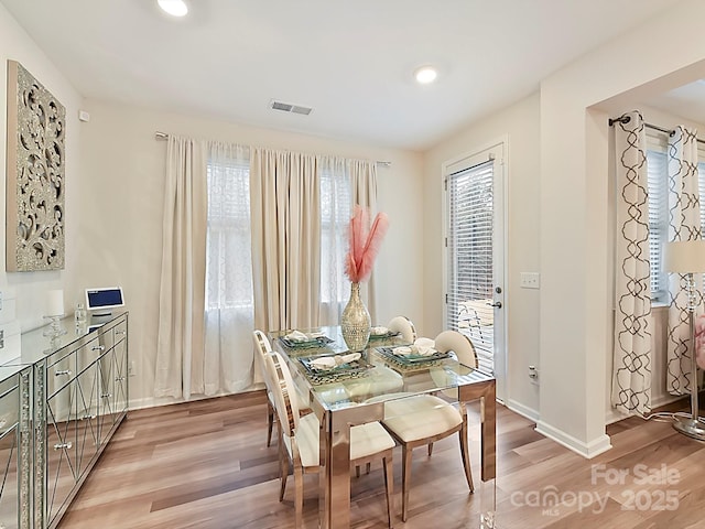 dining area with hardwood / wood-style floors