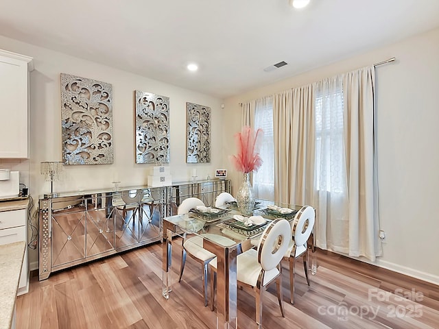 dining space with light hardwood / wood-style floors