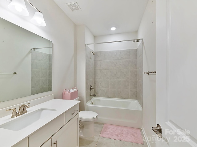 full bathroom with tiled shower / bath combo, toilet, tile patterned flooring, and vanity