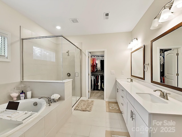 bathroom with vanity, independent shower and bath, and tile patterned floors