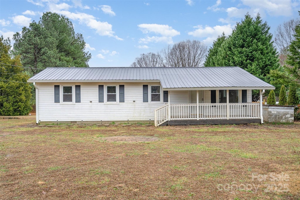 single story home with a front yard and a porch