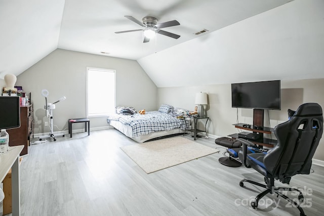 bedroom with ceiling fan, vaulted ceiling, and light hardwood / wood-style flooring