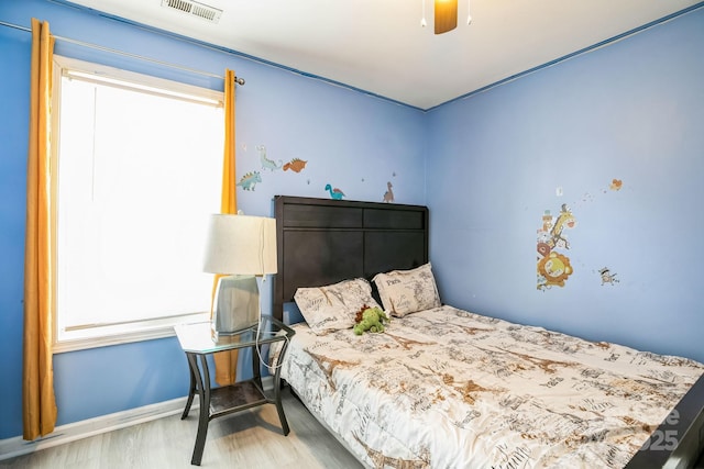 bedroom with ceiling fan and wood-type flooring