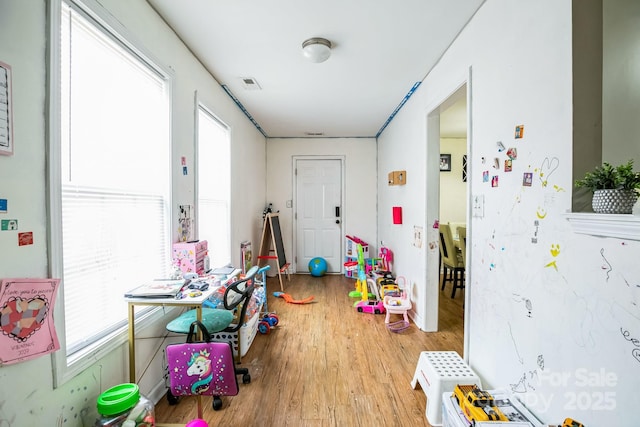 rec room with light hardwood / wood-style flooring