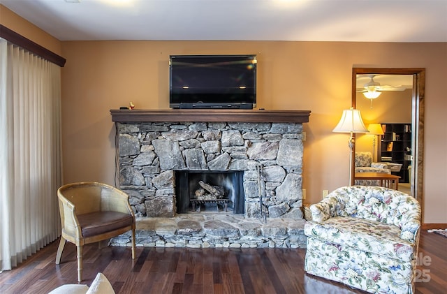 interior space featuring a stone fireplace and wood finished floors