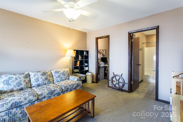 living area featuring light carpet, baseboards, and a ceiling fan