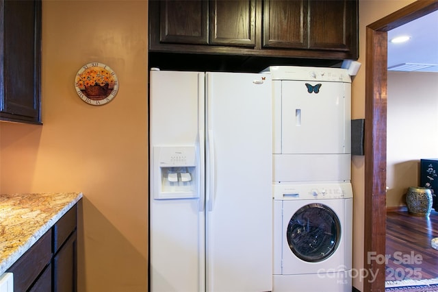 laundry room featuring stacked washer / dryer