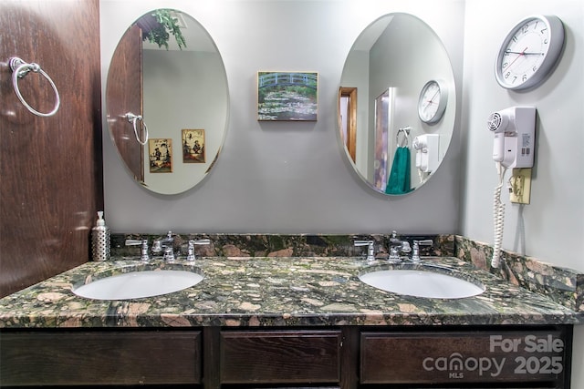 full bath with double vanity and a sink