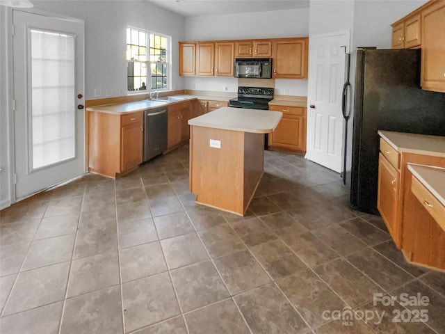 kitchen with sink, black appliances, a center island, and tile patterned floors