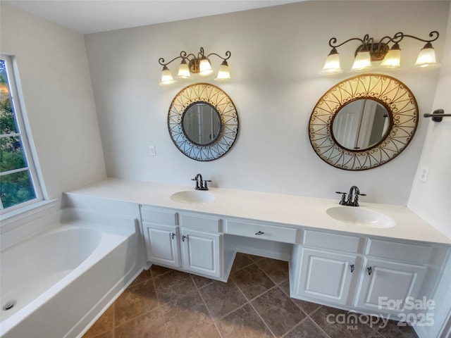 bathroom with a tub to relax in and vanity