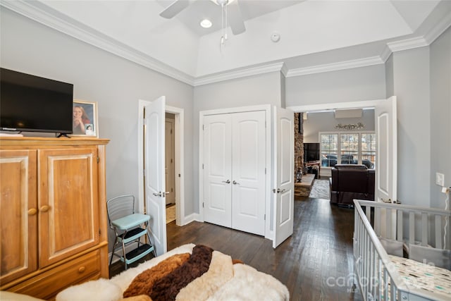 bedroom featuring ornamental molding, dark hardwood / wood-style floors, ceiling fan, and a closet