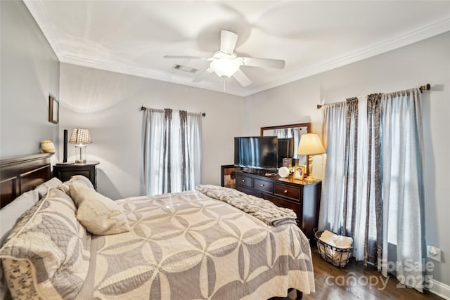 bedroom featuring dark wood-type flooring, ceiling fan, and crown molding