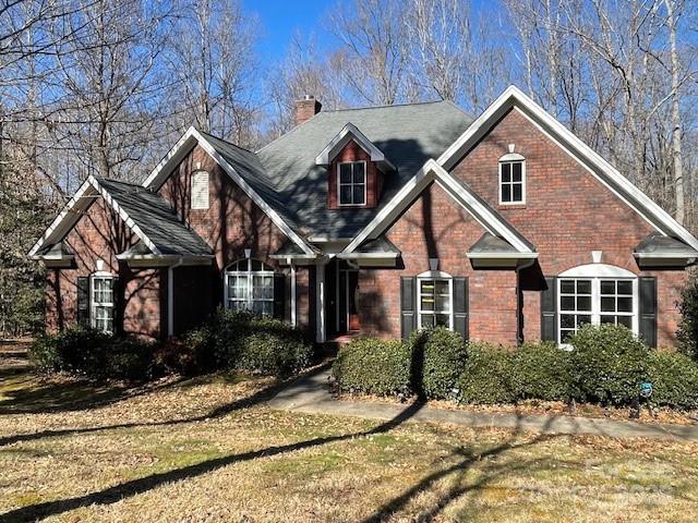 2113 Sweet Clover Way, Denver, NC 28037 - view of front of home featuring a chimney, brick siding, and a front yard