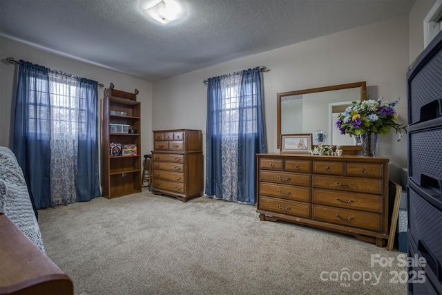 carpeted bedroom featuring a textured ceiling