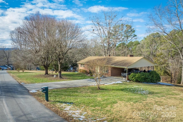 view of front of house featuring a front lawn and a carport