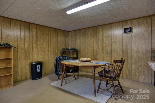 dining room with wooden walls