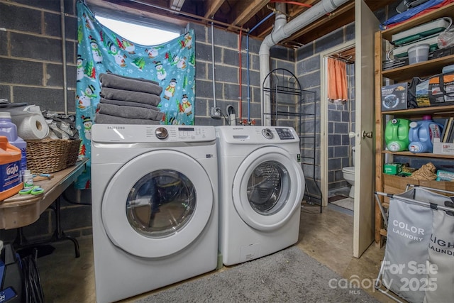 clothes washing area featuring washer and dryer