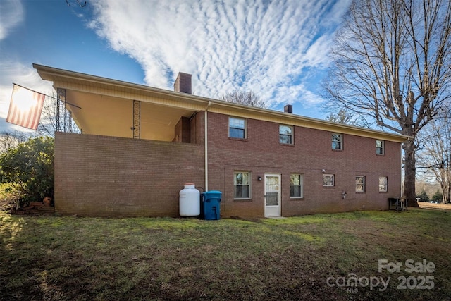 rear view of property with a lawn