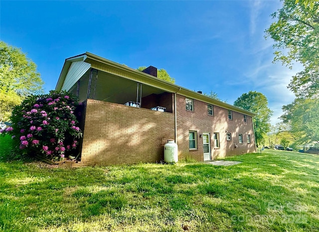 104 Tron Park Ave NE, Valdese, NC 28690 - rear view of house with a lawn, brick siding, and a chimney