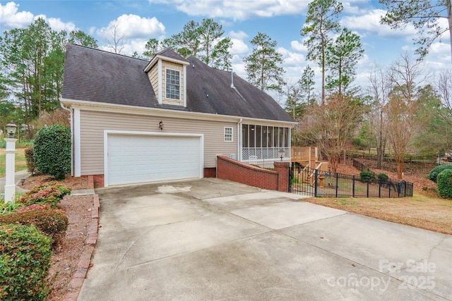 view of property exterior featuring a garage and a sunroom