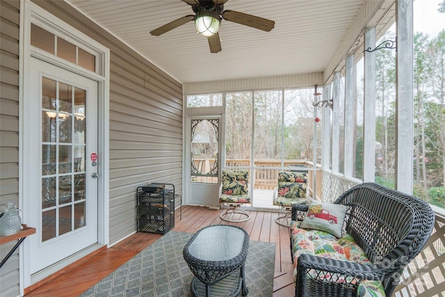 sunroom featuring ceiling fan