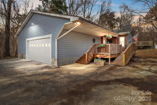 view of front facade featuring a garage and a wooden deck