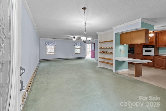 kitchen with a kitchen bar, pendant lighting, light carpet, ornamental molding, and white oven