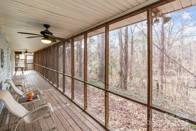 unfurnished sunroom with ceiling fan