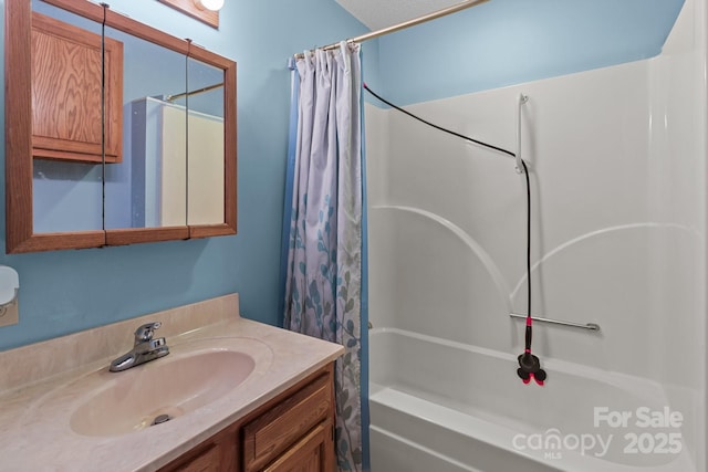 bathroom featuring vanity and shower / bathtub combination with curtain