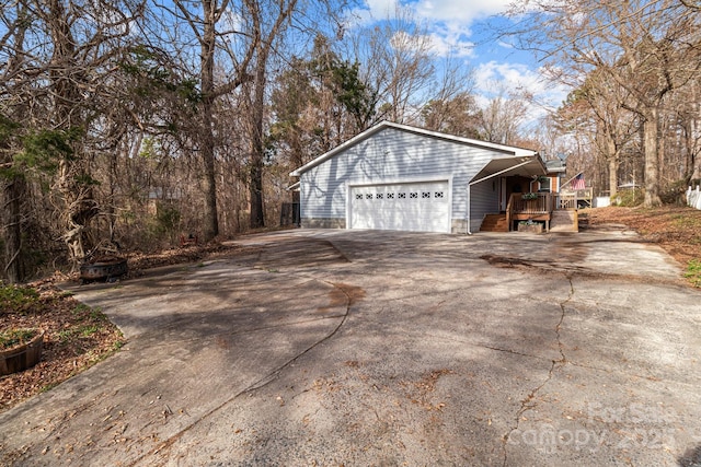 view of property exterior featuring a deck and a garage