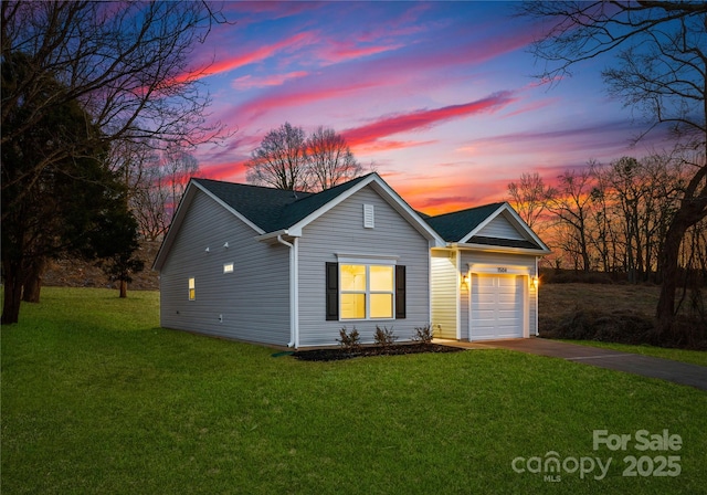 view of front of property with a garage and a lawn