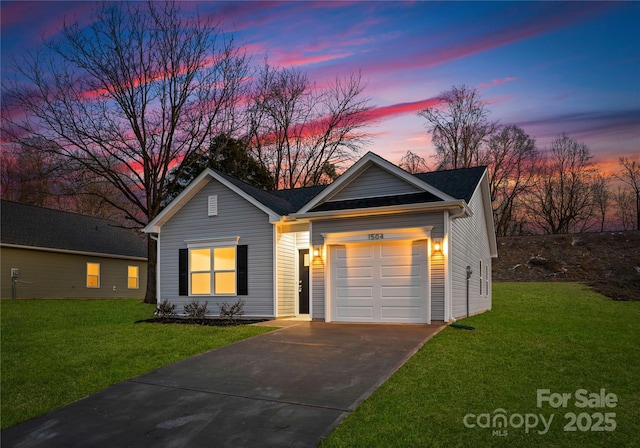 ranch-style home with a garage and a yard