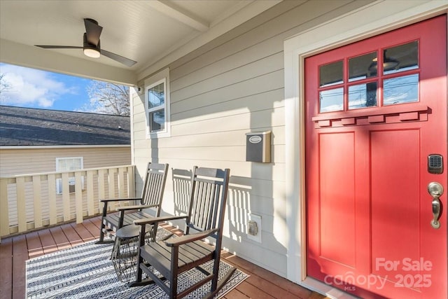 wooden deck featuring ceiling fan and covered porch