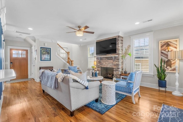 living room featuring crown molding, plenty of natural light, and hardwood / wood-style floors