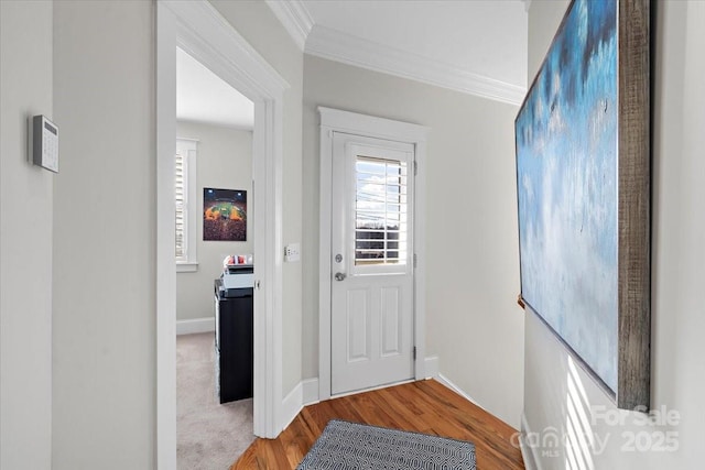 doorway to outside featuring ornamental molding and hardwood / wood-style floors