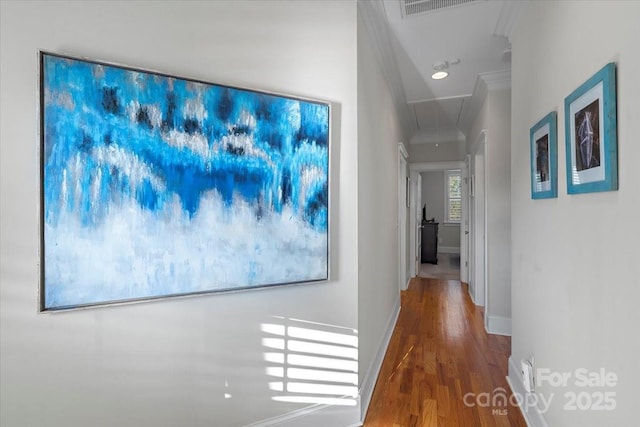 hallway featuring hardwood / wood-style flooring and ornamental molding