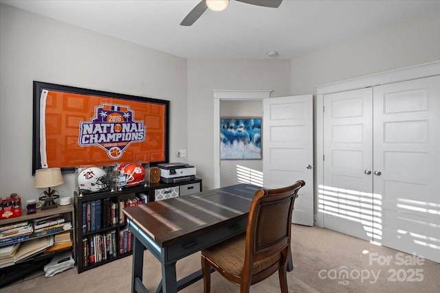 carpeted dining area featuring ceiling fan